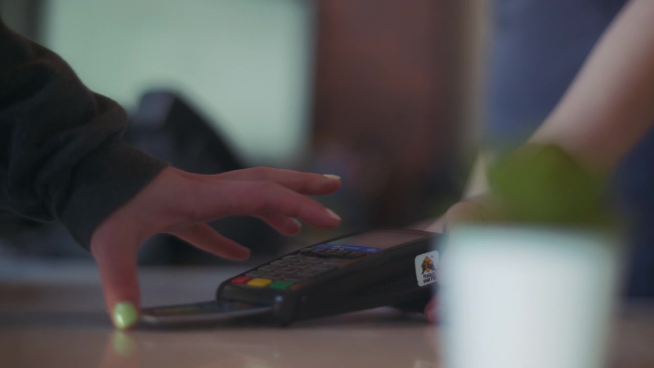 Woman inserting credit card to a machine