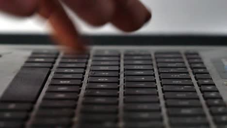 close up of finger typing on a keyboard