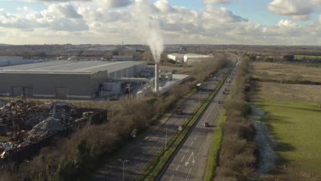 Static-Aerial-shot-with-smoking-chimney-and-scrap-metal-factory