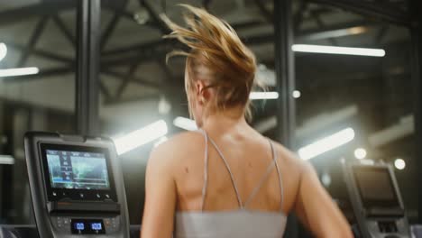 woman working out on a treadmill at the gym