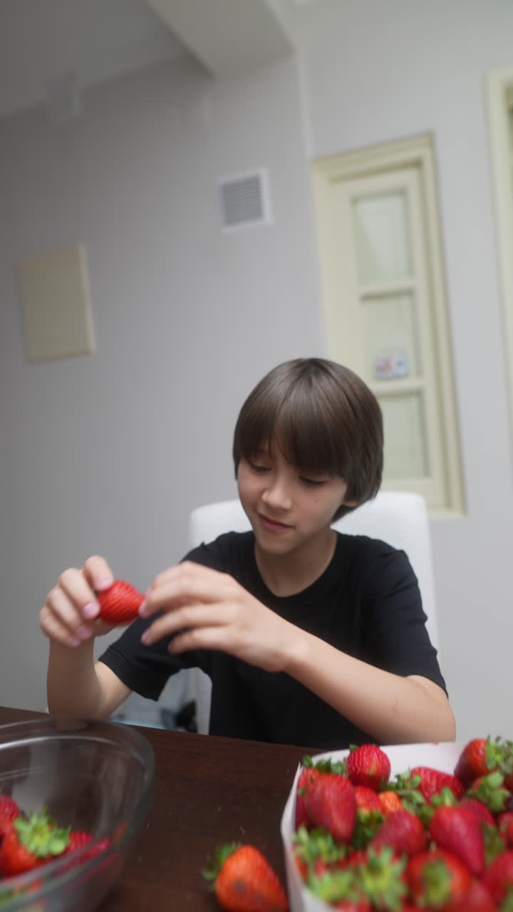 Boy eating strawberries