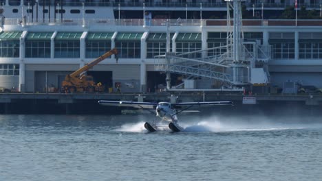 turbo otter seaplane takes off from harbour, front view