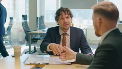 business partners speaking and shaking hands in office