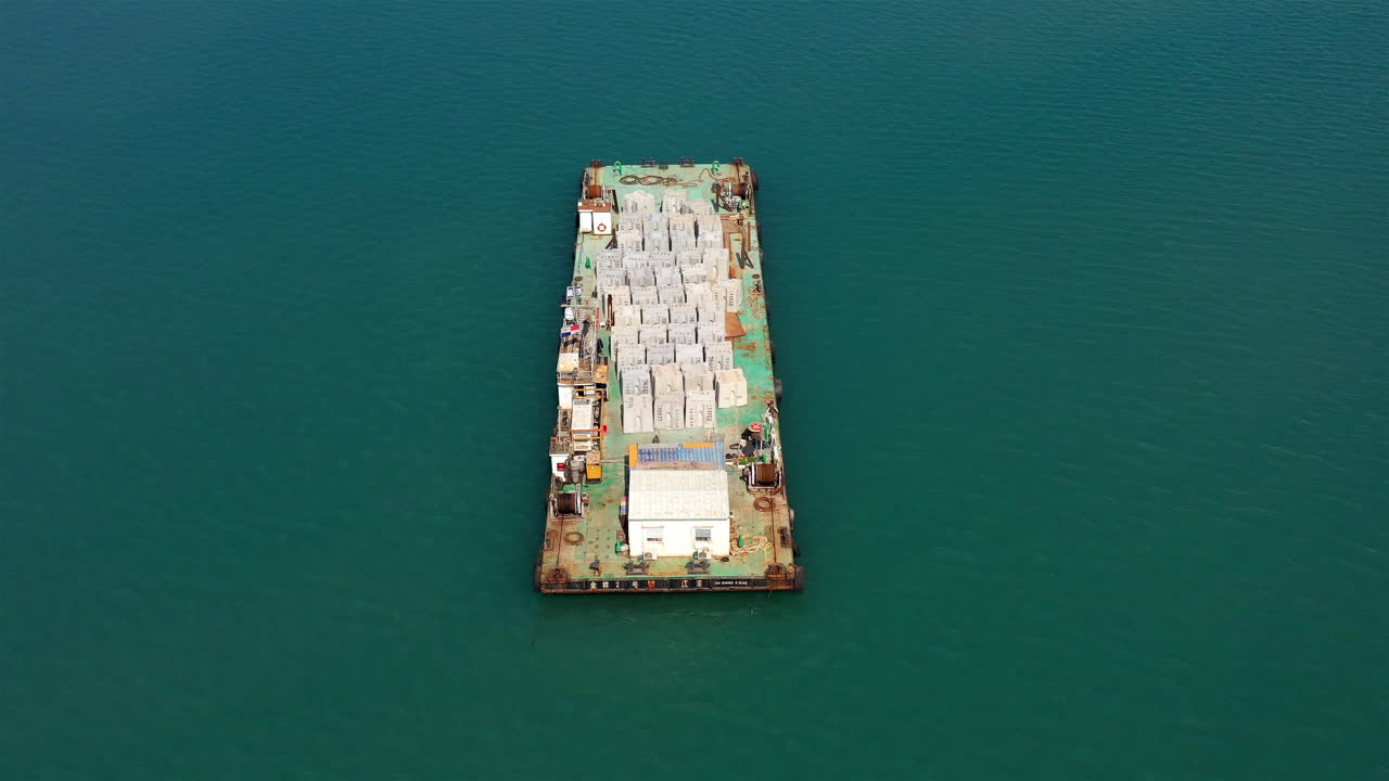 Aerial footage over barge with Concrete construction materials