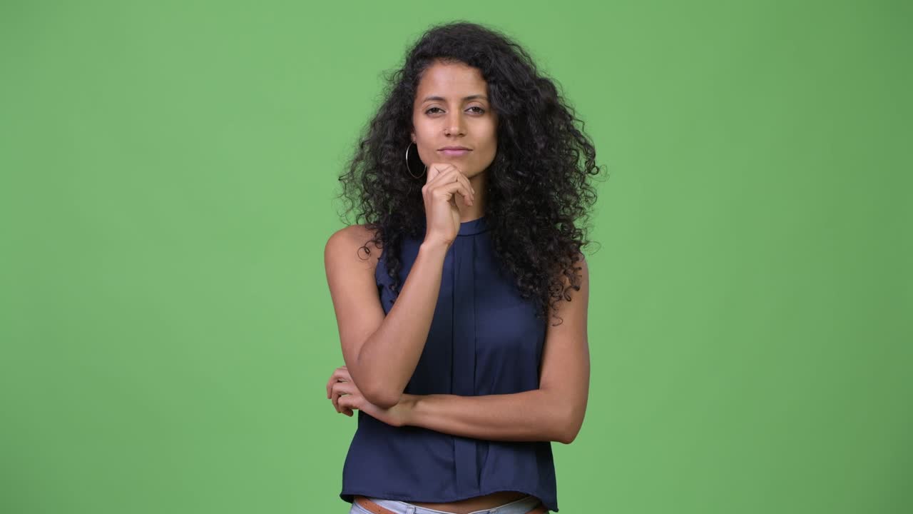 Young beautiful Hispanic businesswoman thinking