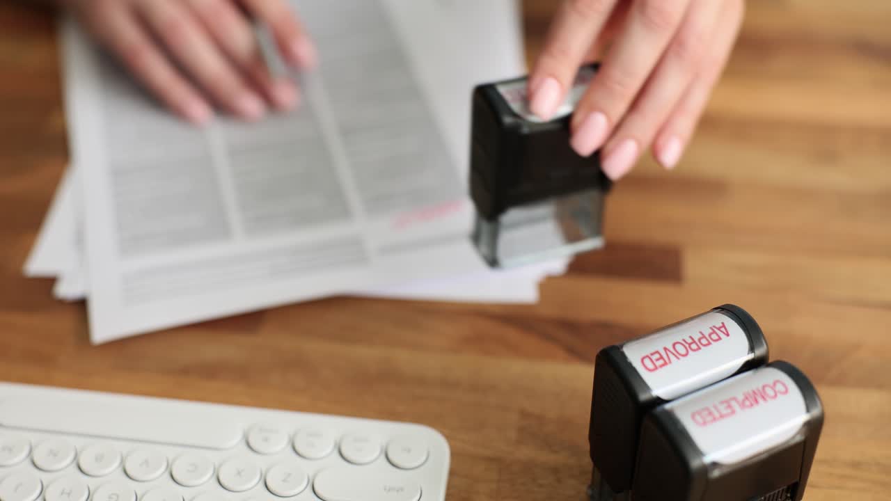 Office paperwork with approved and completed stamps