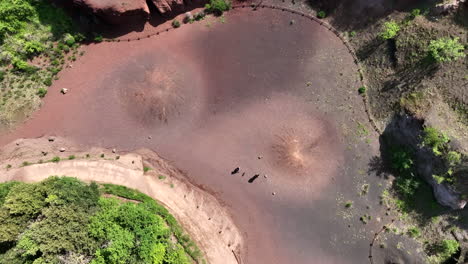 Couple-with-dog-explore-in-volcanic-area-surrounded-by-primitive-nature