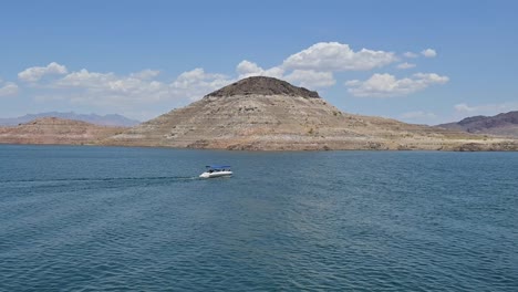 Lake-Mead,-Small-Boat-in-front-of-Island-with-Bathtub-Ring