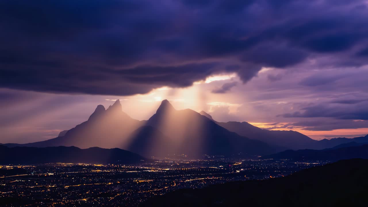 Dramatic Sun Rays Over City and Mountains at Twilight