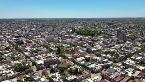 Drone-shot-flying-over-Gualeguaychú,-Entre-Ríos,-Argentina-towards-the-city-center-on-a-clear,-sunny-day