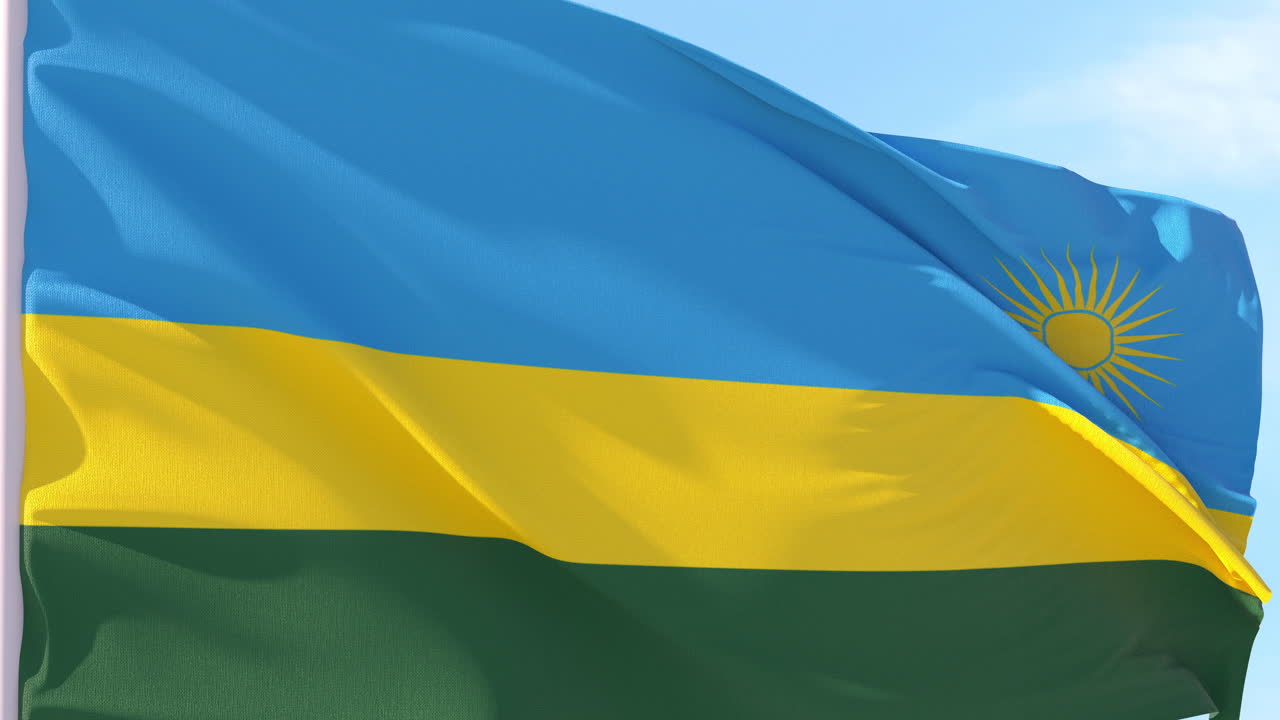 Bandiera del Ruanda che sventola al vento contro un cielo blu