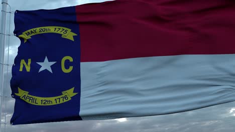 flag of north carolina waving in the wind against deep beautiful clouds sky