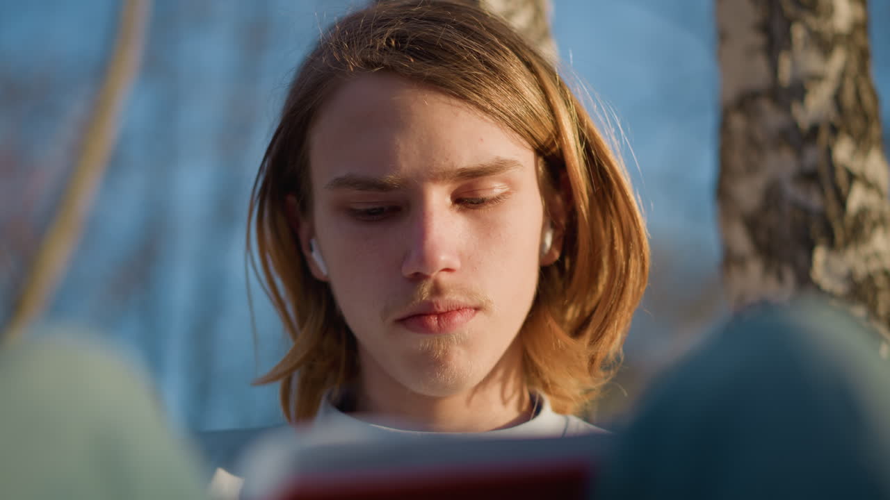 Молодой человек читает на природе, ребенок мирно смотрит на страницы, юноша под деревьями погружен в свои мысли, девушка наслаждается чтением под защитой ветвей березы на природе