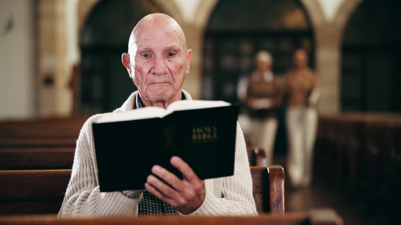 Elderly man reading the Bible in church