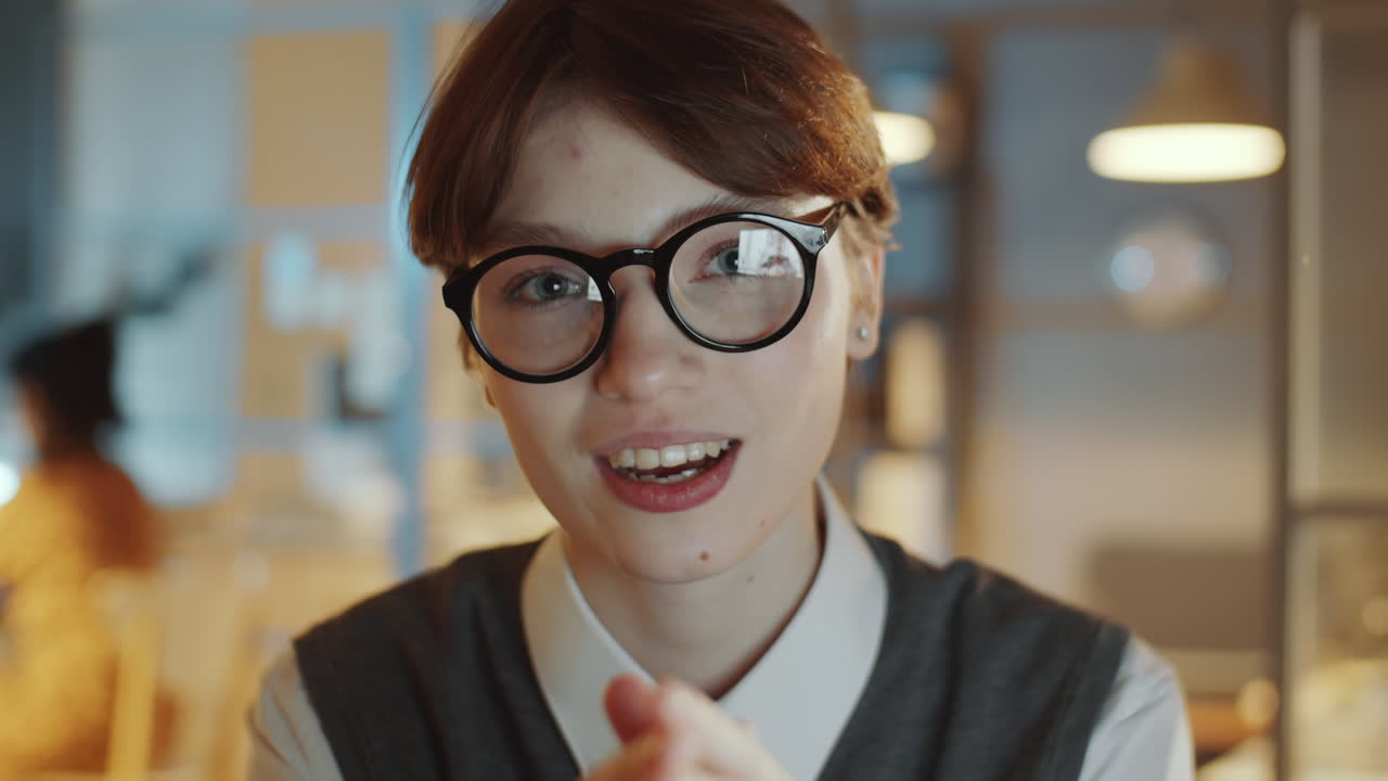 Young Businesswoman Speaking on Camera in Night Office