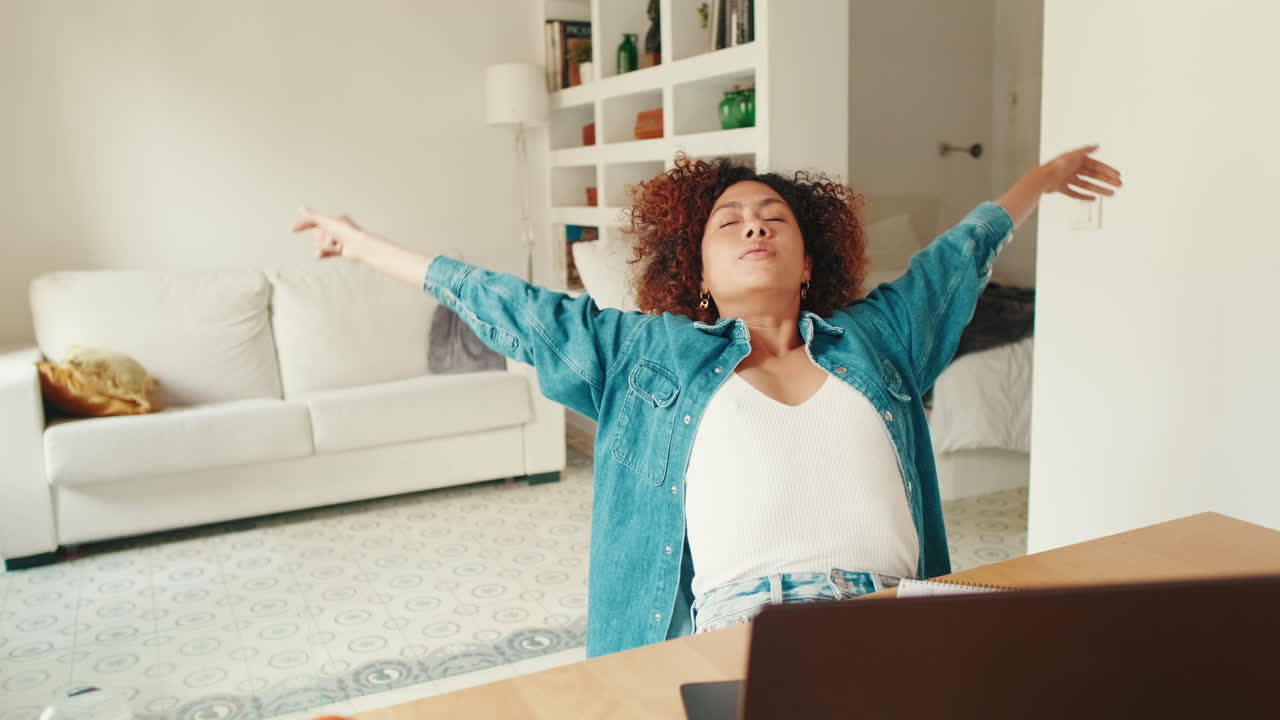 Young Woman Stretching and Relaxing During Work Break at Home