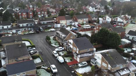 snowy aerial village residential neighbourhood winter frozen north west houses and roads tilt down