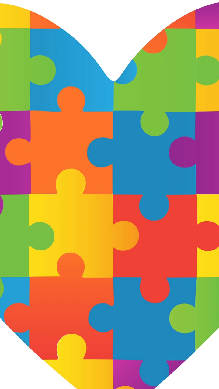 Animazione di puzzle rossi e gialli che cadono su un cuore, in un contesto di puzzle a tema mese della consapevolezza sull'autismo.