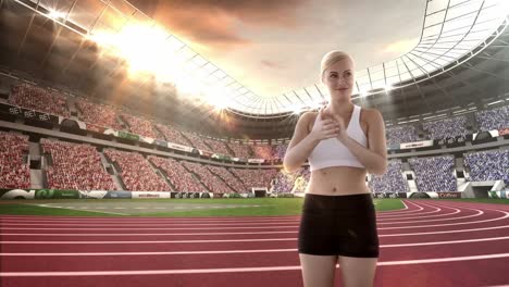 Female-athlete-clapping-hands-in-stadium