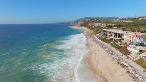 Foamy-Waves-Splashing-Sandy-Shore-In-Dana-Point,-California,-United-States---Drone-Shot