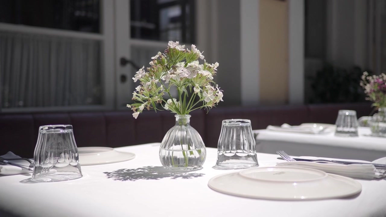 Elegant Table Setting with Flower Vase in Restaurant