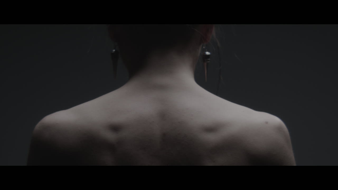 A woman dressed as mother nature shows her back