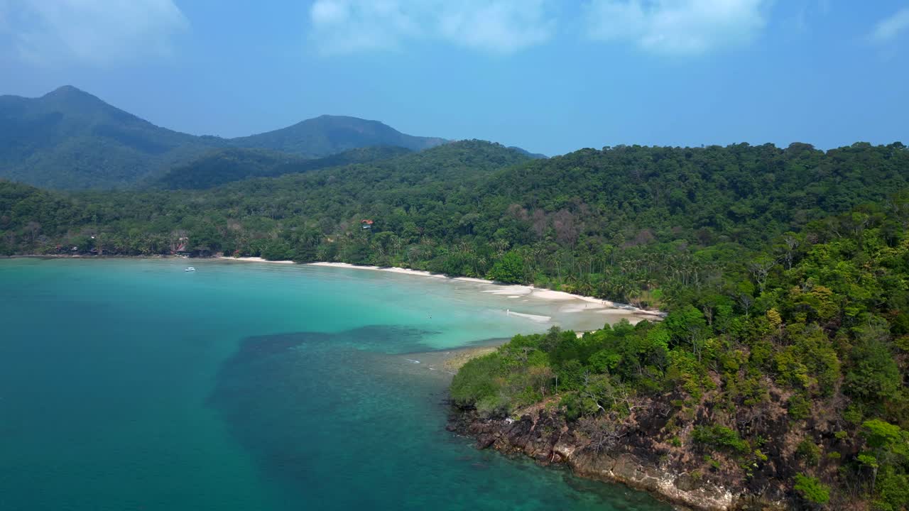 ong beach at koh chang island showing turquoise water and green rainforest in Trat Province, Thailand. Great aerial view flight ascending drone
