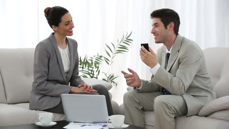 businessman recording meeting with colleague