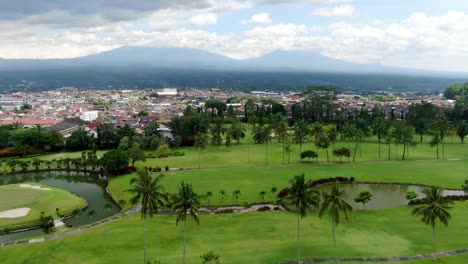 mount merapi and merbabu behind city of yogyakarta, aerial fly forward view