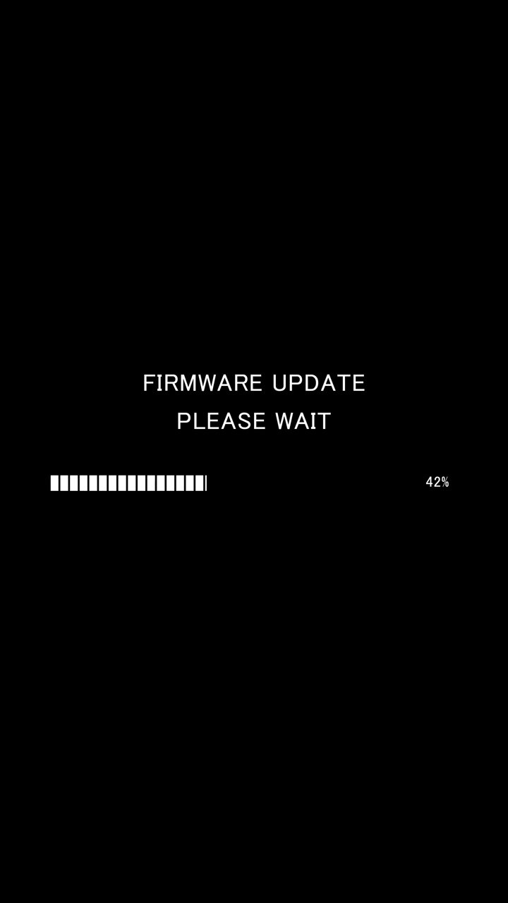 Vertical video of loading progress bar with on-screen text firmware update please wait on black background