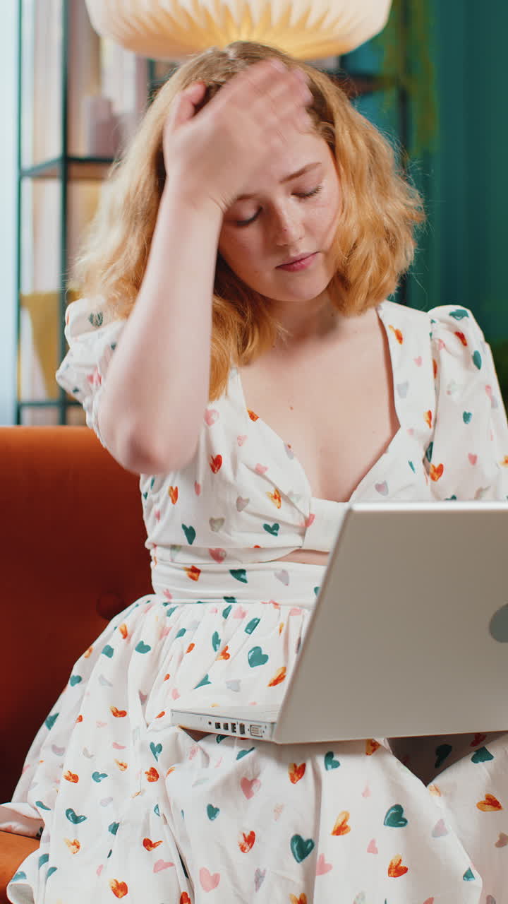 Pretty redhead woman use laptop surprised by bad news fortune loss fail lottery results at home