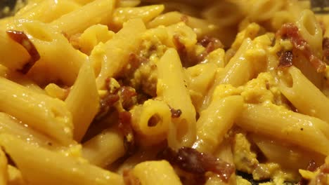 making an iconic italian dish called pasta carbonara, close up shot