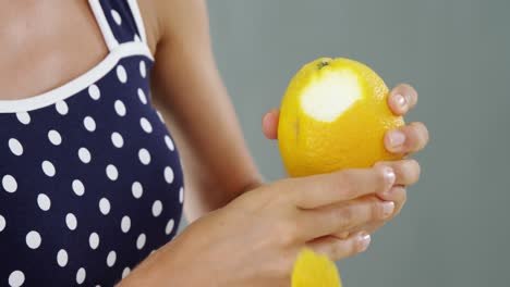 woman peeling orange