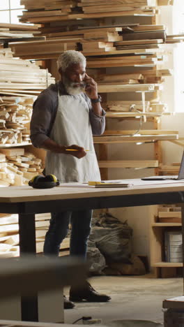 african american craftsman in a woodworking workshop, with copy space