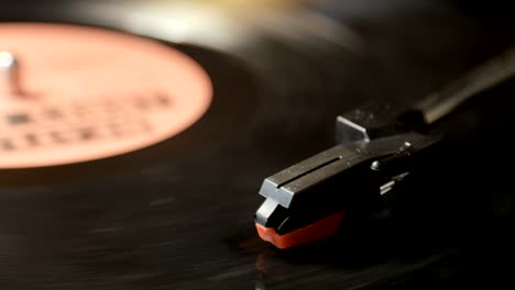 close-up of using an antiquarian vinyl record player. turntable player,dropping stylus needle on vinyl record playing