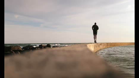 African-American-male-jogger-running-on-the-beach-4k