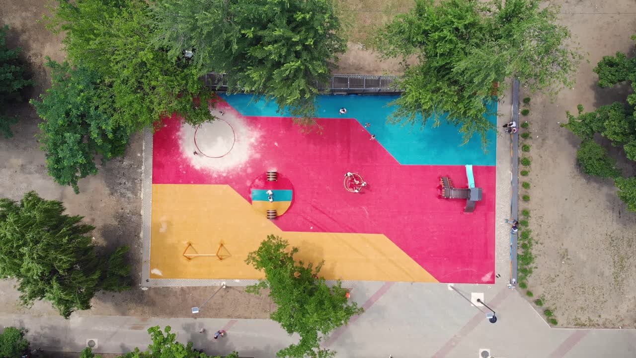 Children play on colorful playground in the park