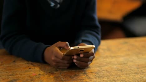 student using mobile phone in the classroom at school 4k