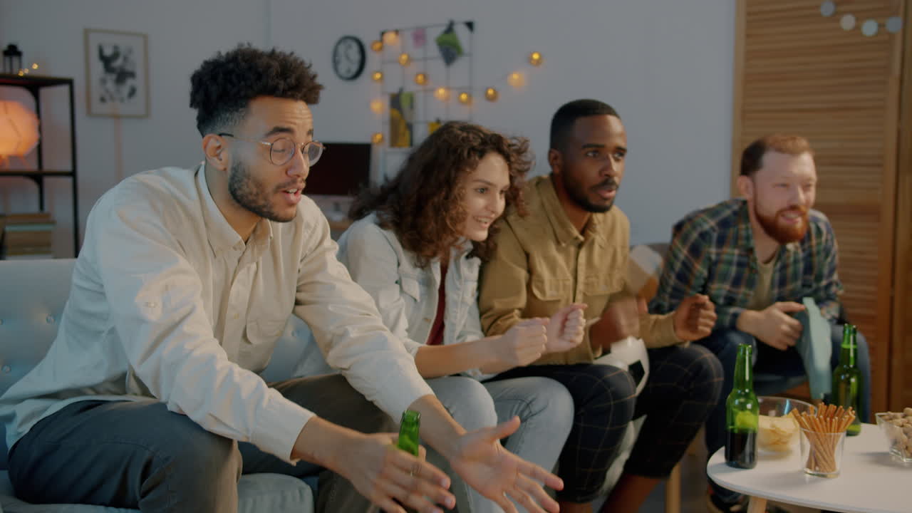 Friends watching a sporting event at home