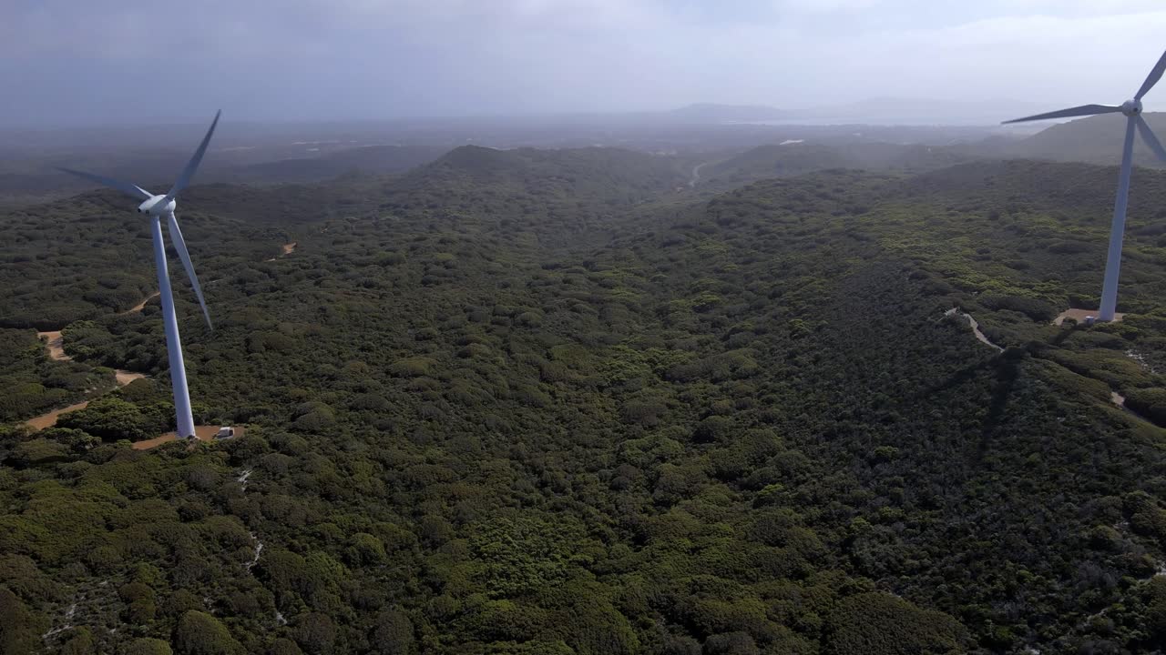 Aerial drone, flying slowly towards two windmills at the Albany wind farm Western Australia