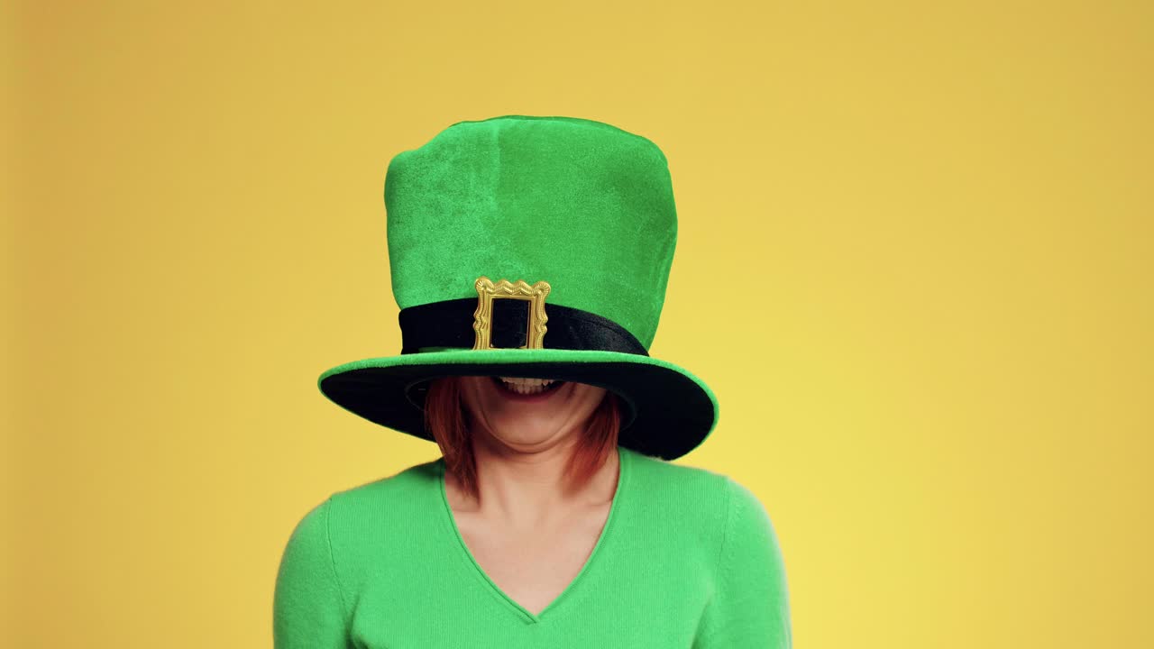 Playful woman having fun with leprechaun's hat