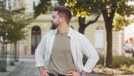 man looking for someone waiting for meeting angry frustrated look time touching wristwatch on street