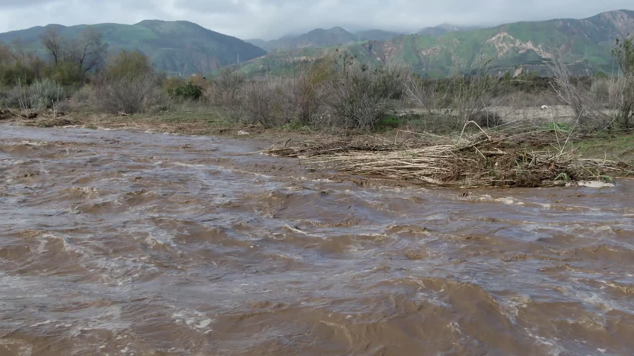 fast moving flood waters in southern california, santa clara river dry wash after heavy rain