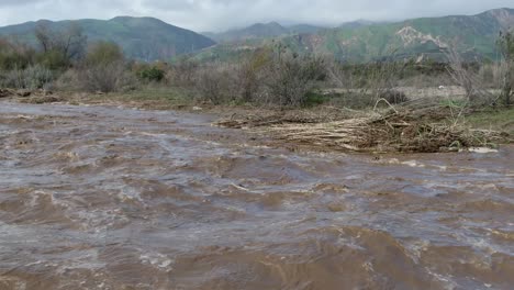 fast moving flood waters in southern california, santa clara river dry wash after heavy rain