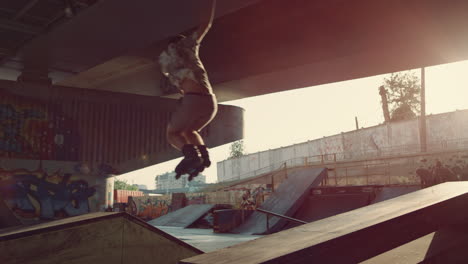 sporty teenage boy performing jump trick in roller skates at urban skate park.