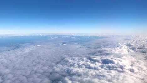 Timelapse-video-as-airplane-rises-above-and-through-layers-of-clouds