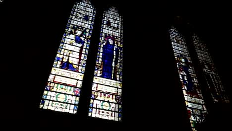 Panning-shot-of-stained-glass-windows-within-Westminster-Abbey,-London,-England