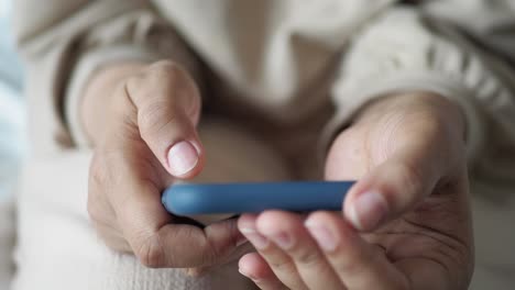 Primer-Plano-De-La-Mano-De-Una-Mujer-Sosteniendo-Un-Teléfono-Inteligente