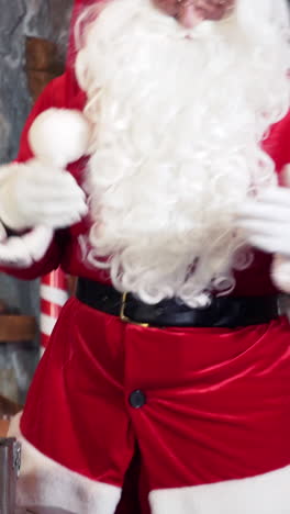 santa with white beard in red costume indoors. santa claus singing merrily in his residence. vertical video