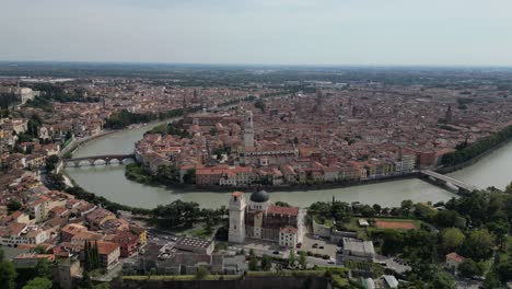 city is filled with historical architecture and buildings with the river flowing through the centre and providing a natural charm vibrant atmosphere man-made diverse elements structures bird view